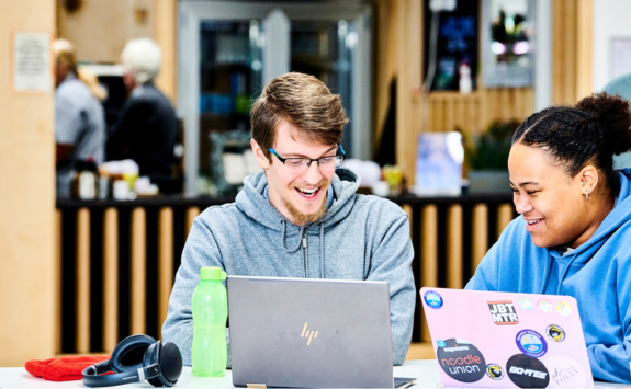 Two students looking at laptops